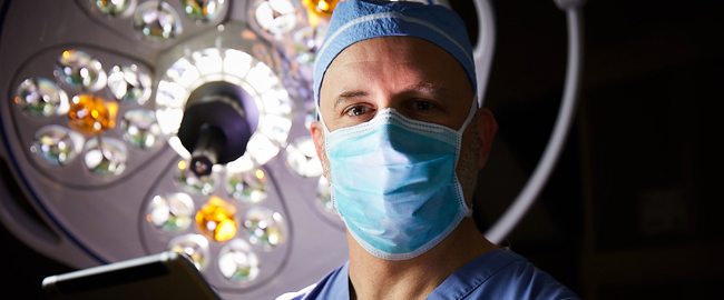 Physician with surgical light in background