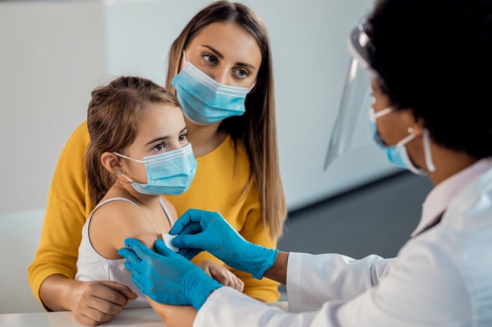 Young Girl with Parent Getting Vaccinated