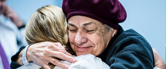 Female Medical Person and Female Patient Hugging