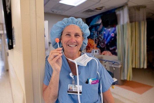 pediatric surgical nurse smiling with a lollipop