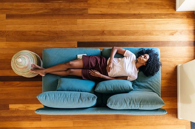 Woman napping on couch.