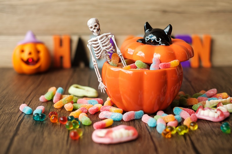 Halloween candy, ghost candies, pumpkin bowl, Jack O lantern and decorative set up.