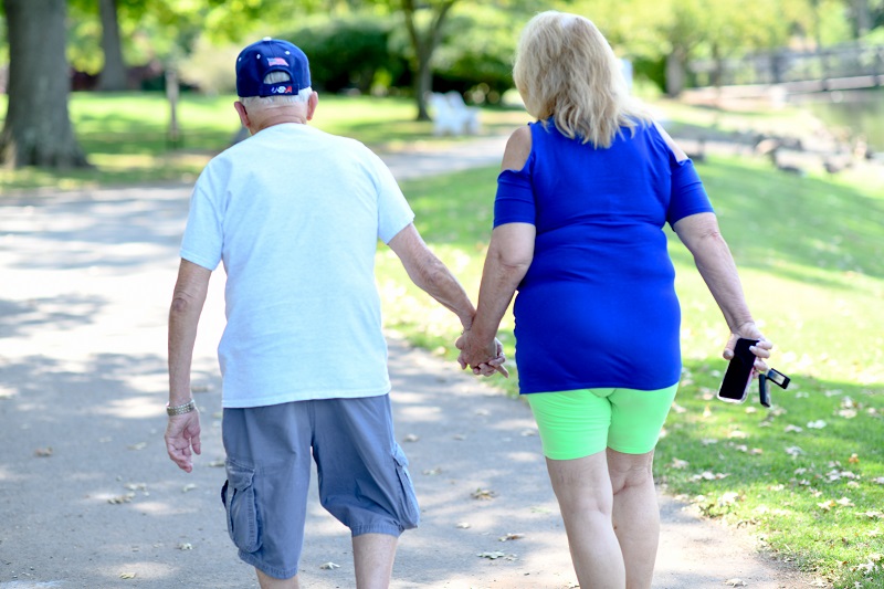 Elderly couple walking in the park. Walking decreases risk for dementia 
