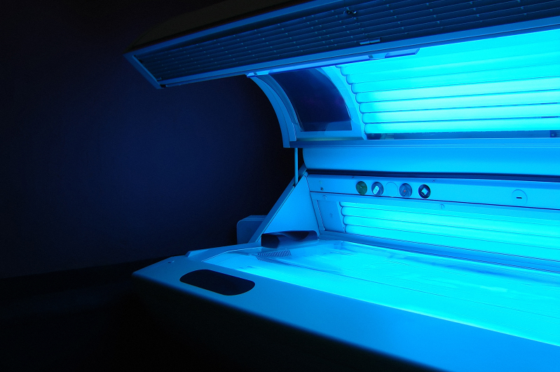 tanning bed ajar with the lights on