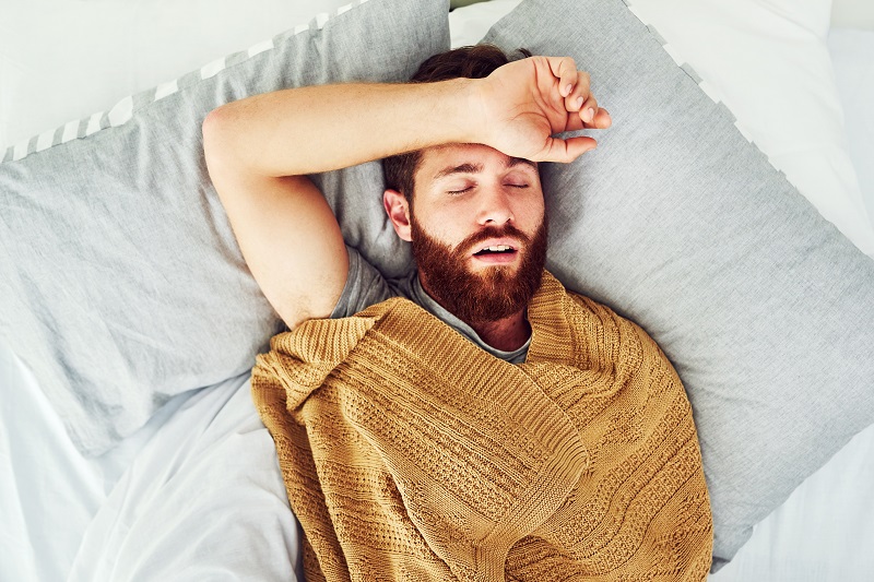 Man snoring and asleep, dealing with sleep apnea