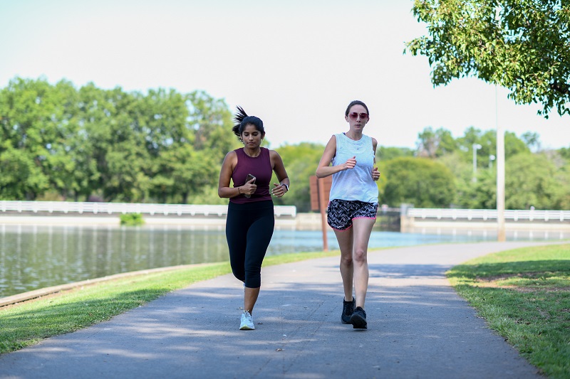 Two young women jogging in the park together