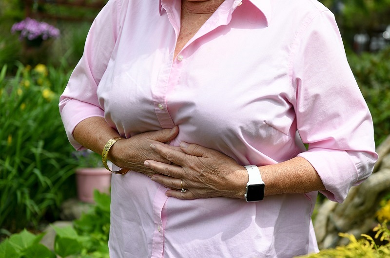 Woman clutching her stomach from pain