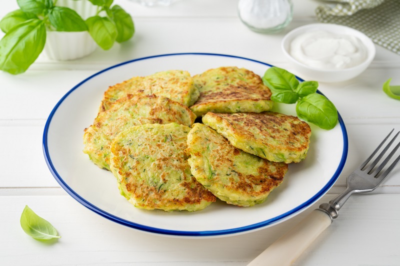 Zucchini fritters paired with creamy labneh.
