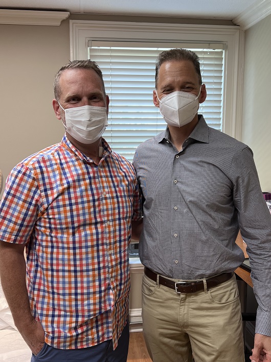 Gerald Branim standing next to his surgeon Matthew Kaufman, M.D., standing close and smiling. 