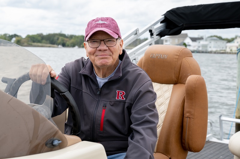 Ed Bechold on his boat smiling. 