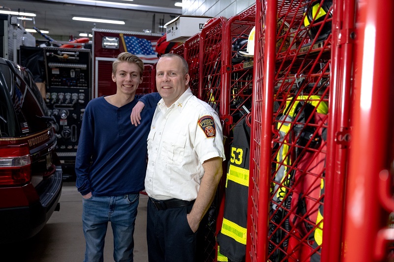 Teenager Mark and his father David inside the Woodbridge fire station.