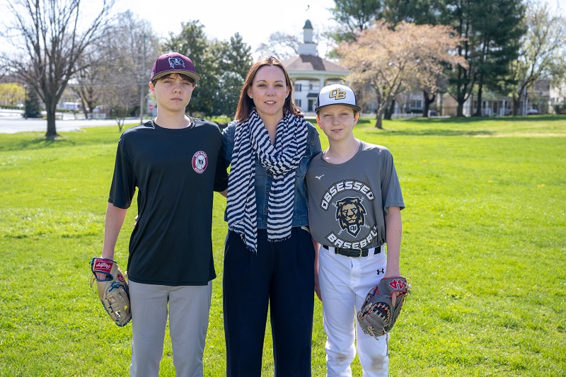 Jennifer Biedinger and her sons on a baseball field.