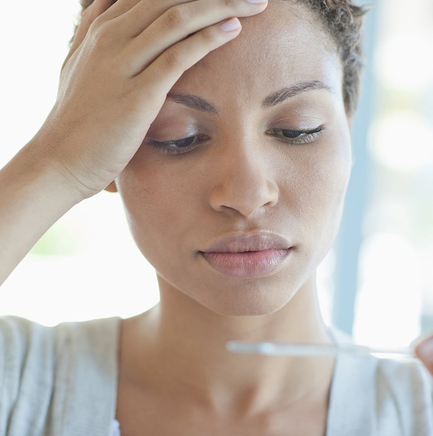 Woman with hand on forehead