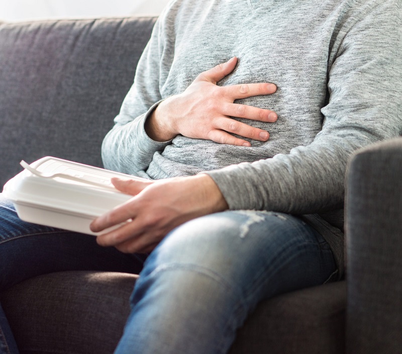 Person with hand over abdomen