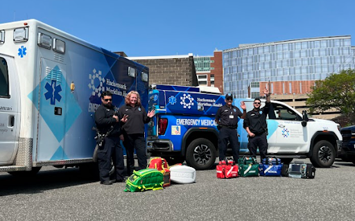 Hackensack Meridian Health paramedics and EMS teams standing next to their vehicles