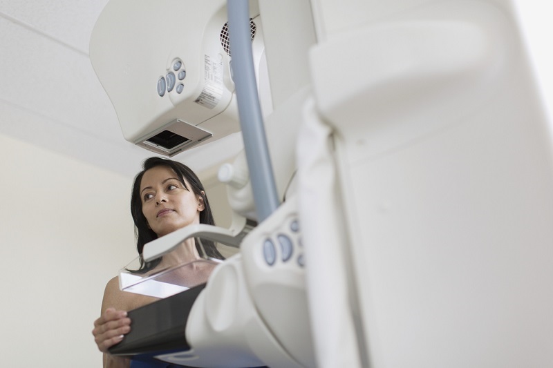 View from below of female patient having mammography