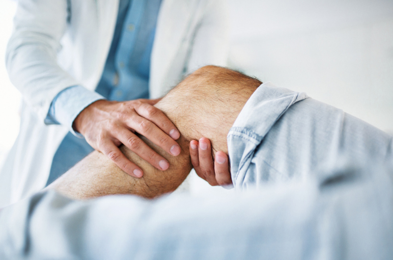 Image of patient with arthritis consulting with a physician.