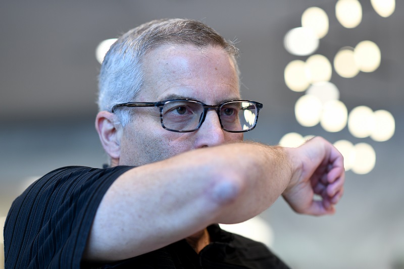 Man coughing into his elbow.