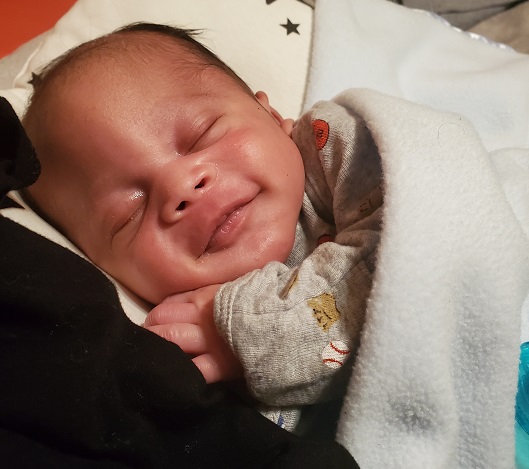 Baby Marcel snuggling and cozy wrapped in a blanket