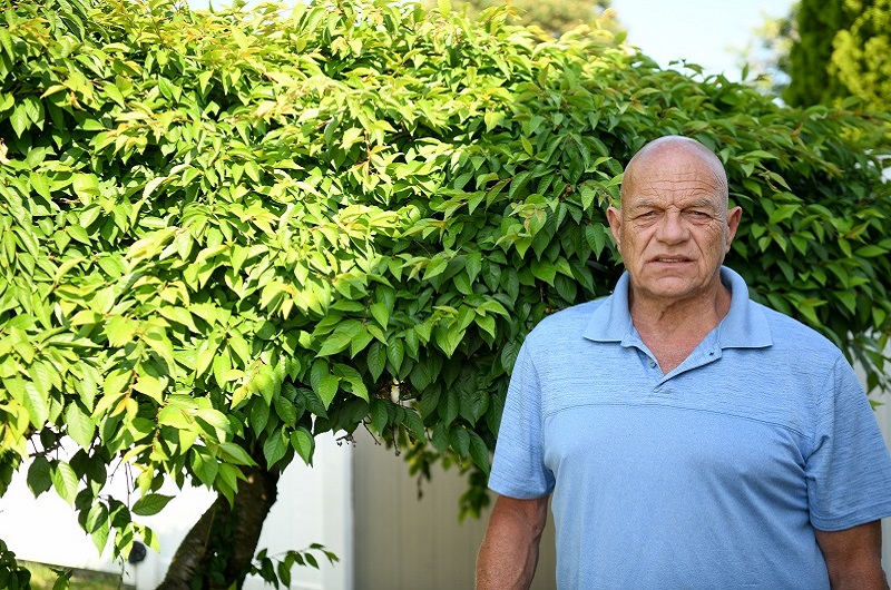Patient James Roe standing outside