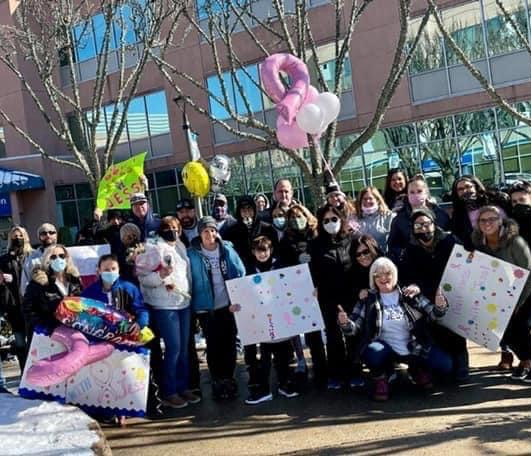 Supporters of Jess Wilkinson standing with signs that say 'Don’t Mess With Jess' to support her cancer treatment