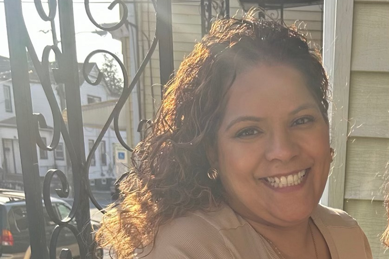 Crystal smiling on a front porch.