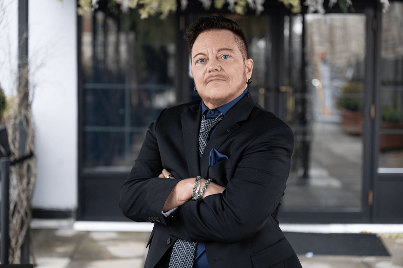 Micky Petrillo, 60, looks at the camera with his arms folded in front of him.