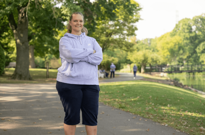 Linda Hayes of Somerville, New Jersey, stands in a park outside with her arms folded.