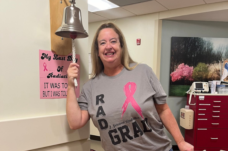 Jody Orth rings a bell signifying the end of her breast cancer treatment.
