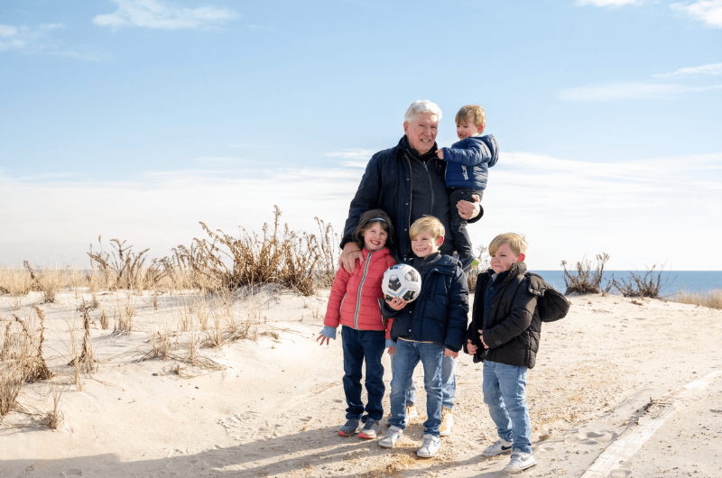 74-year-old Gene Hayman plays with his four grandchildren on the beach.