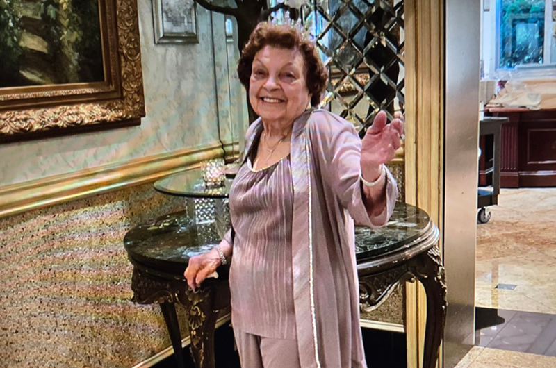 While dancing, 100-year-old Fannie Mutchko smiles at the camera.