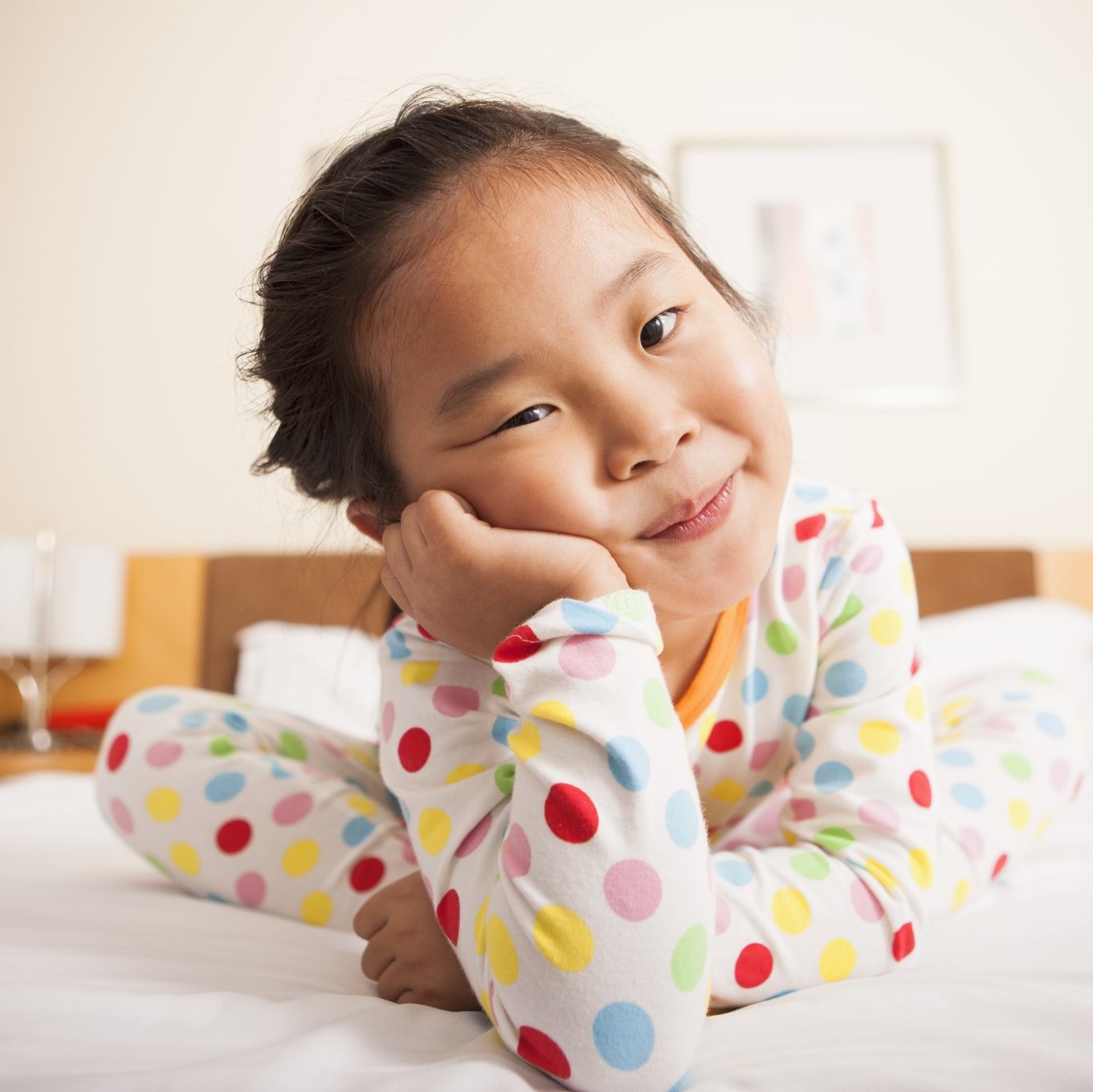 Child sitting on bed