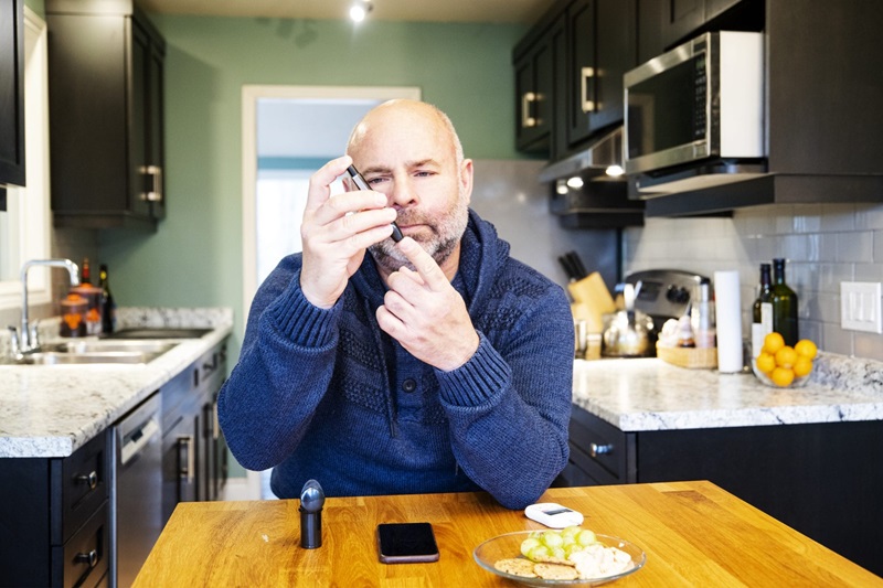 Male Diabetic Patient Pricking Finger