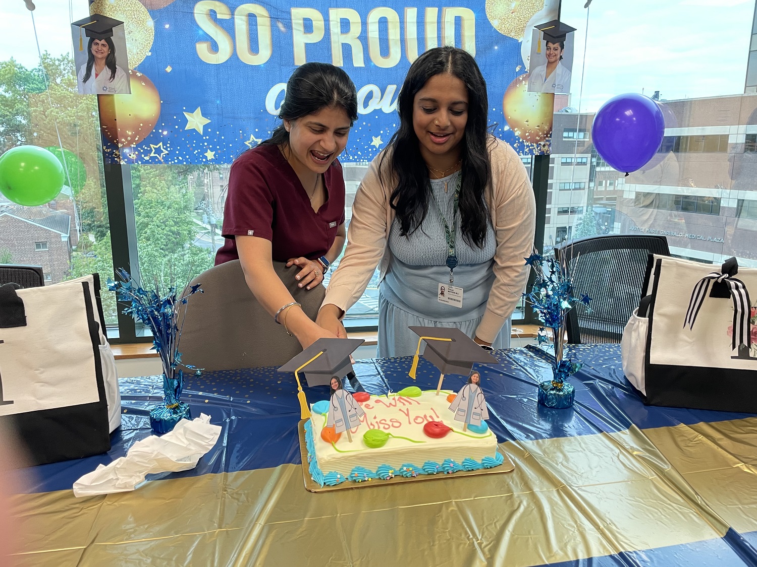 Drs. Puri and Matthew with graduation cake.