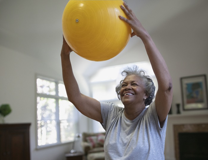 Older Woman Exercising with Yoga Ball