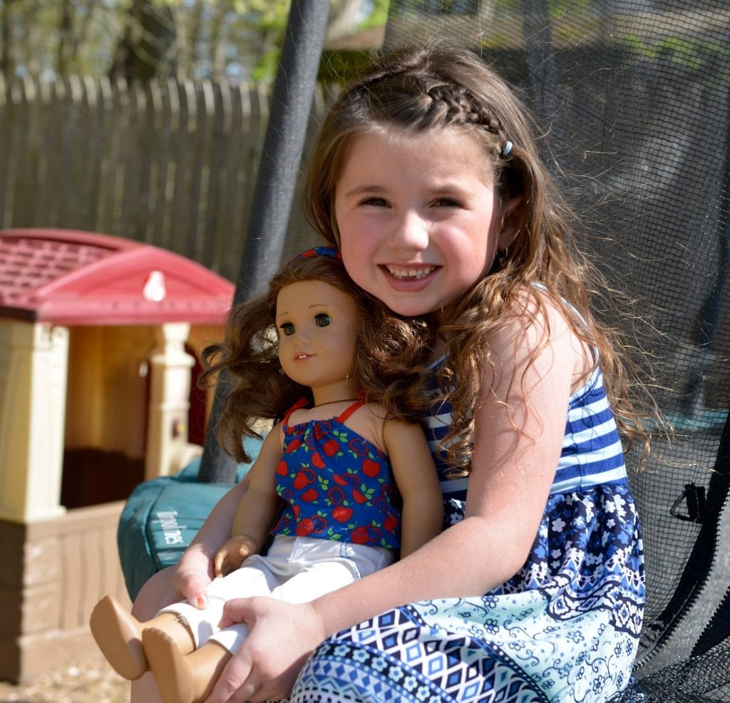 Child smiling with doll