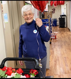 Elderly women holding heart shaped ballons