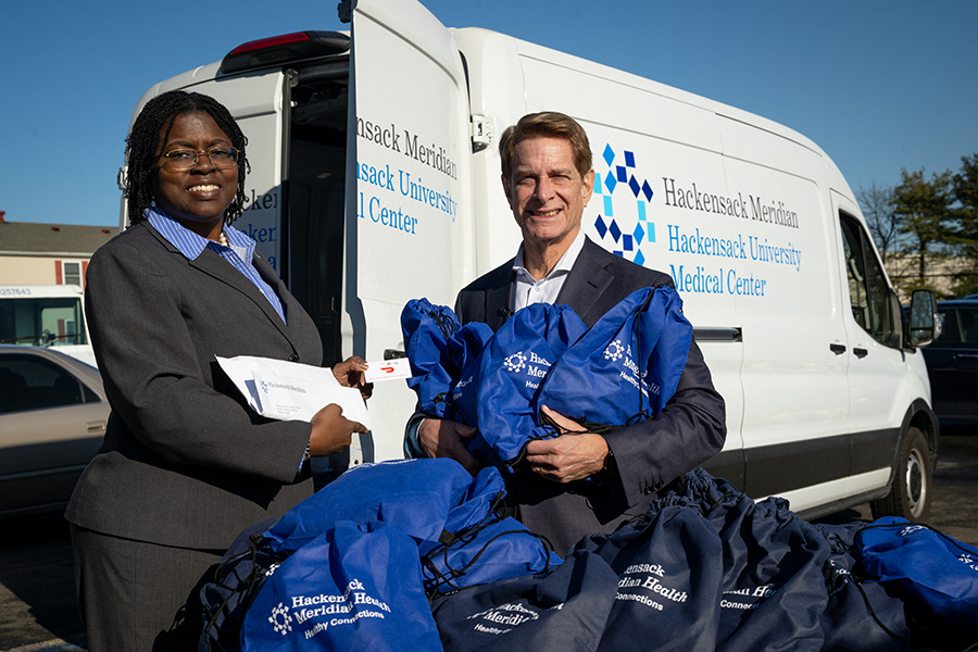 HMH CEO Bob Garrett with VP Nicole Harris-Hollingsworth donating goods during Day of Connection