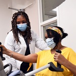 Provider observing patient doing physical therapy