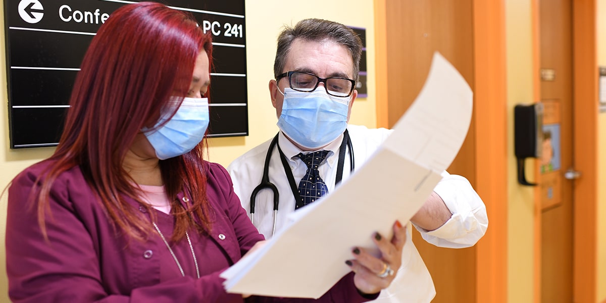 Doctor reviews chart with nurse