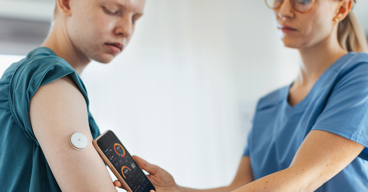 Doctor helping patient with CGM