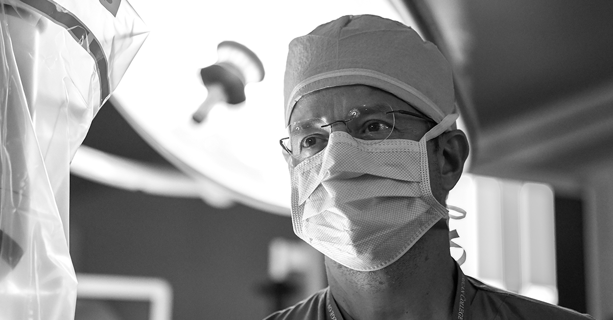 black and white image of physician in operating room