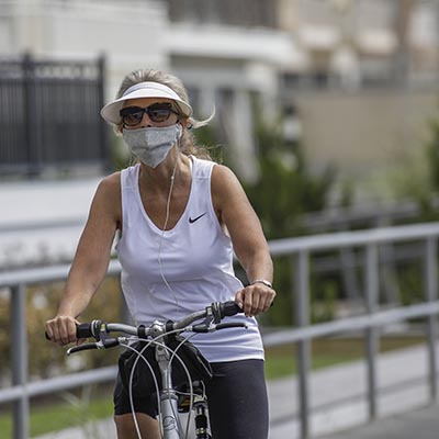 Woman wearing a mask at the shore
