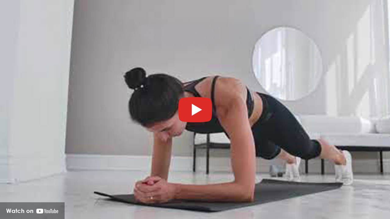 Woman performing a plank exercise on a mat