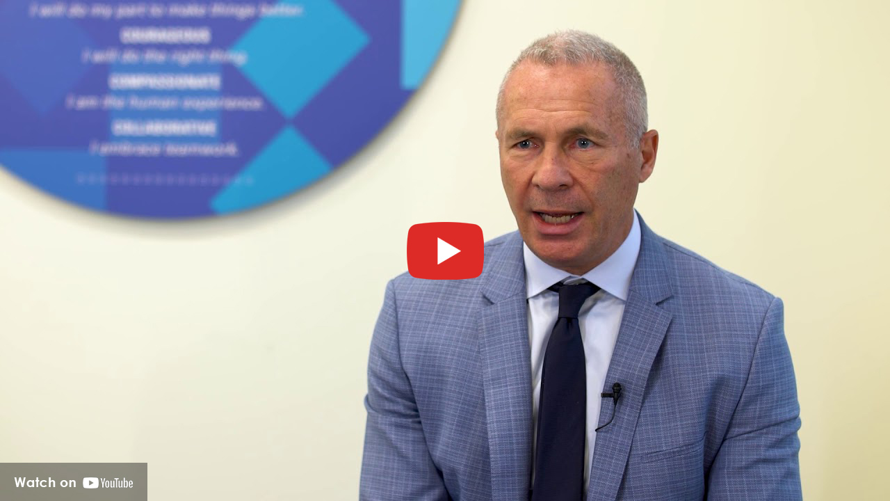 Doctor sitting in lab coat talking to patient